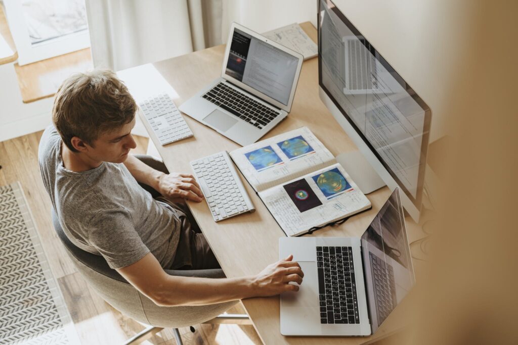 Man Using 3 Computers