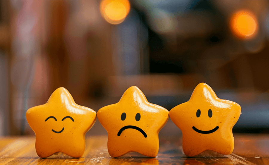 Three star-shaped cookies with different smiles.