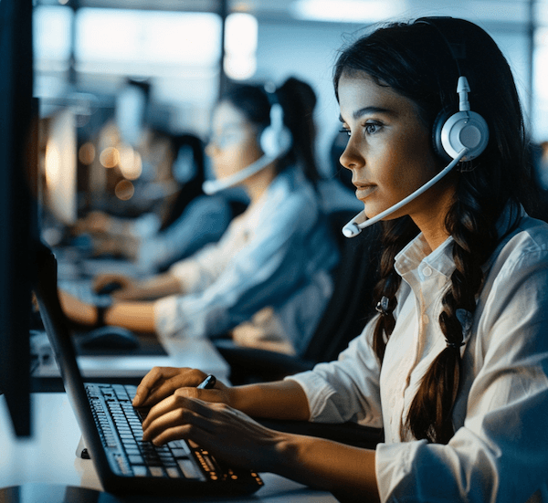 Call centre operators working with headsets and computers.