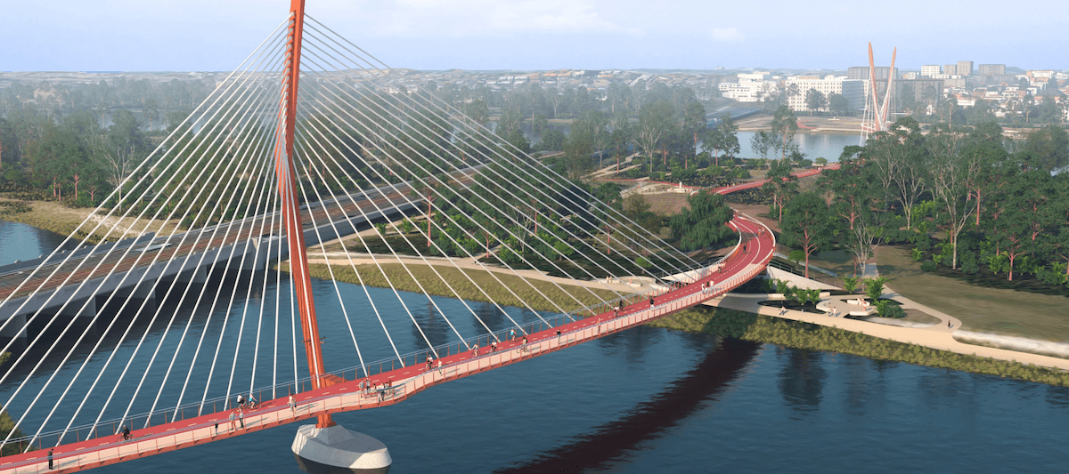 Modern suspension bridge over river in urban park