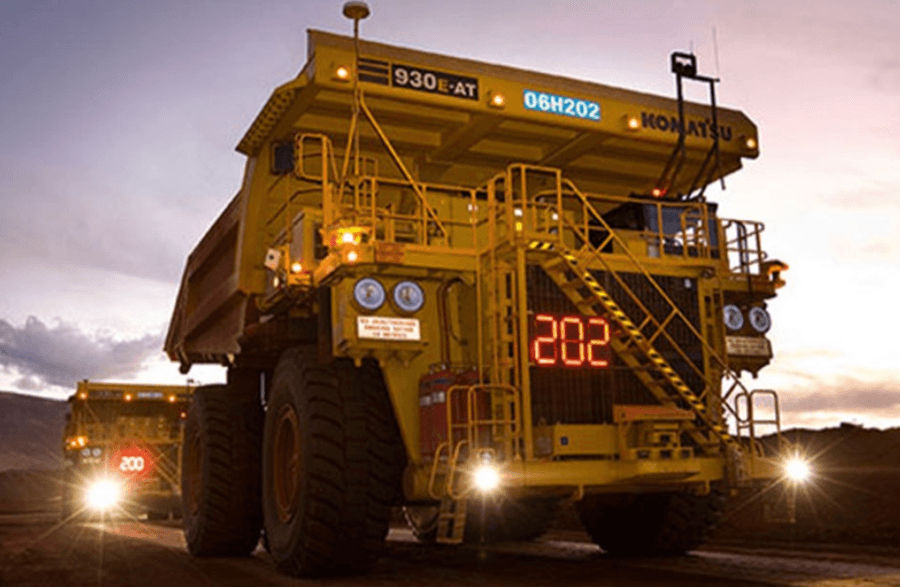 Massive mining trucks operating at dusk in Australia